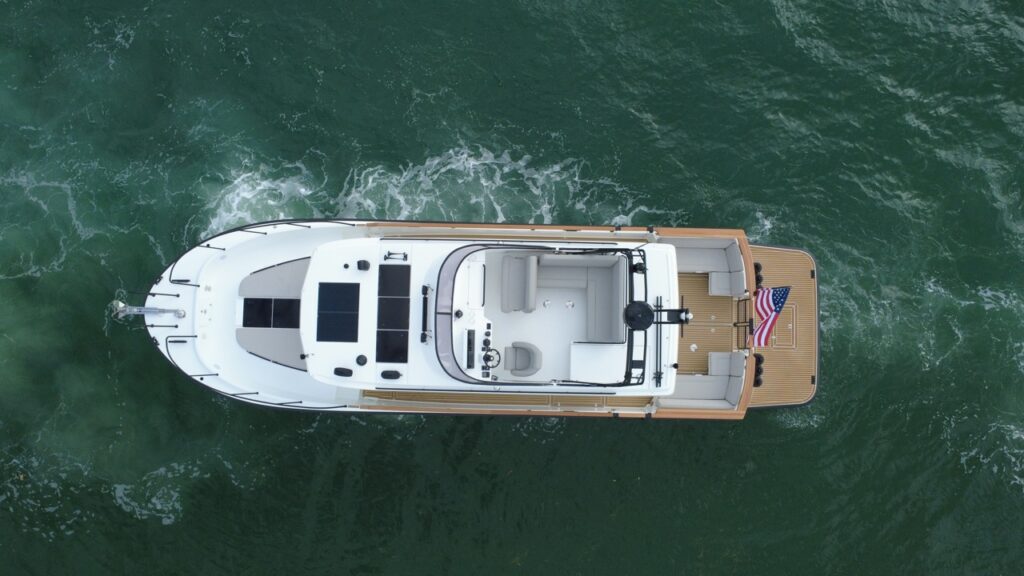 Overhead aerial view of a Targa 41 cruising in Florida waters, showing the flybridge, solar panels, walkaround decks, and aft cockpit with swim platform.