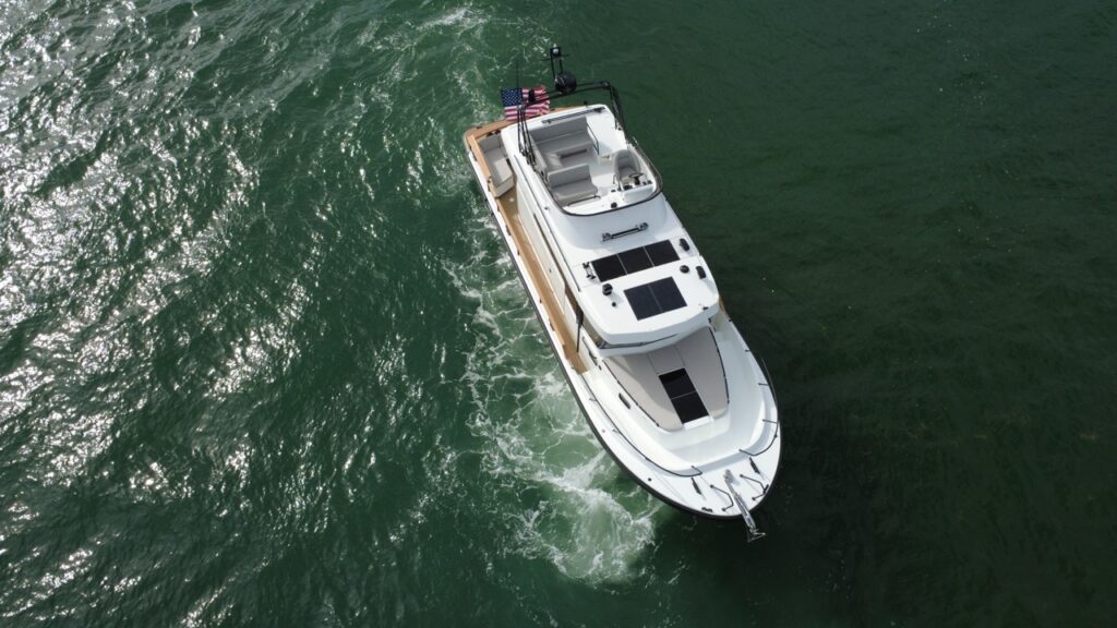 Overhead aerial view of a Targa 41 cruising in Florida waters, showing the deck layout, solar panels, and pilothouse roof.