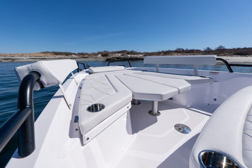 Axopar 29 bow seating area with table and Chalk upholstery