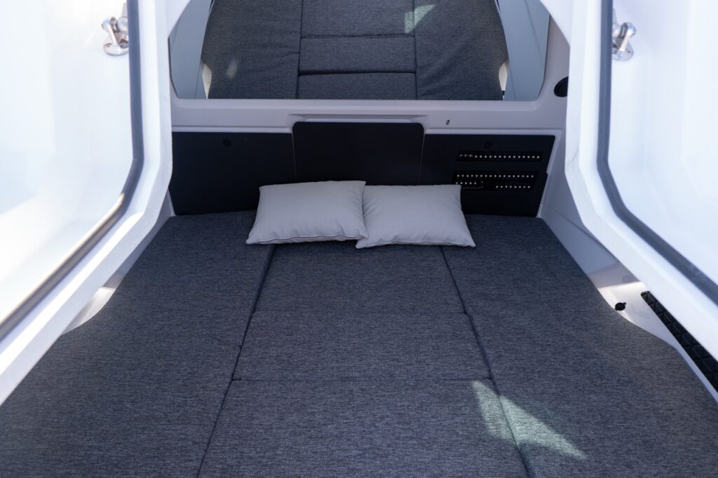 Axopar 29 forward cabin double berth with gray cushions and pillows