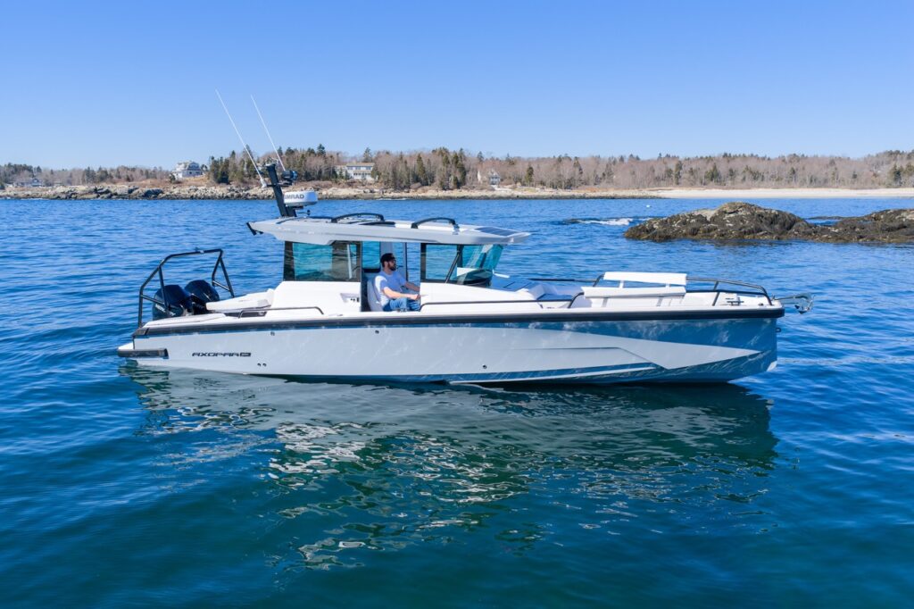 Side profile of Axopar 29 Cabin with Platinum Gray hull and Chalk upholstery on calm water