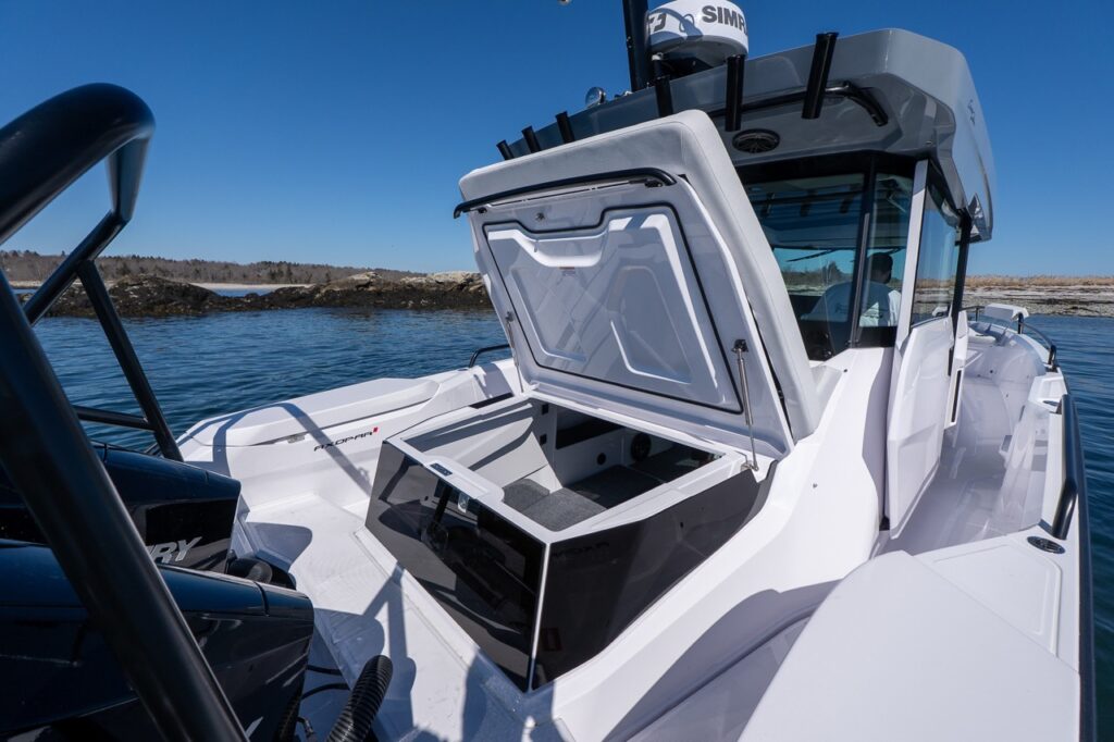 Axopar 29 aft deck storage compartment open behind the pilothouse showing large gear locker