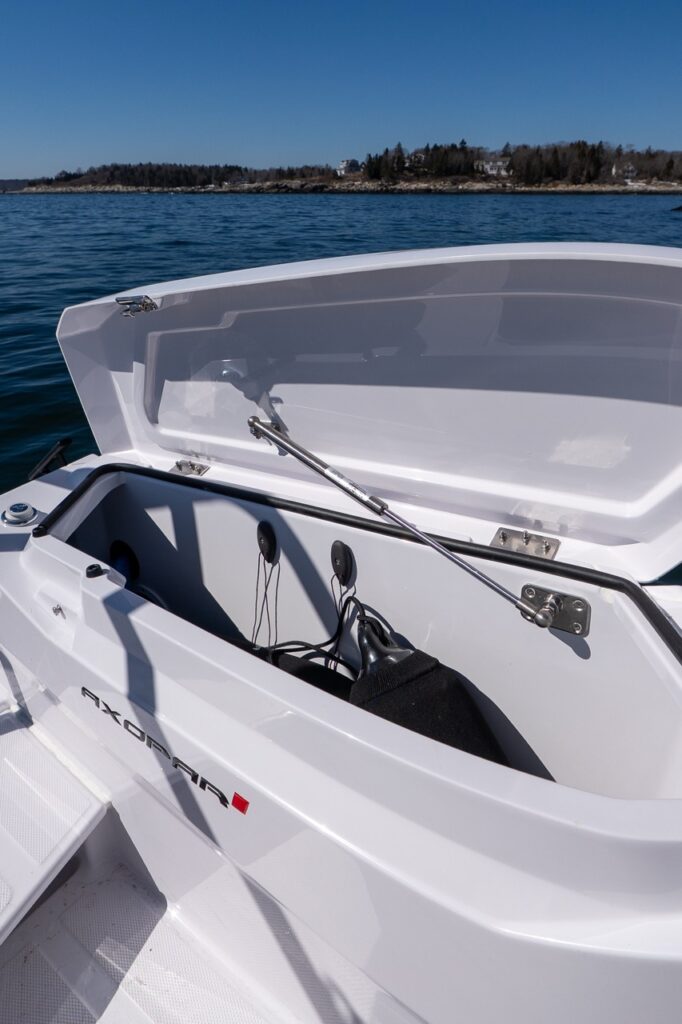 Axopar 29 side deck fender storage locker open with fender and docking gear inside