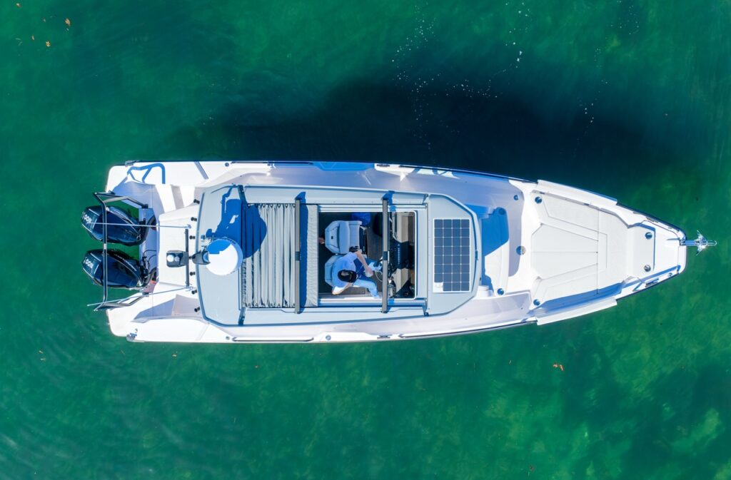 Top-down aerial view of Axopar 29 Cabin with Platinum Gray hull, Chalk upholstery, and solar panel on pilothouse roof