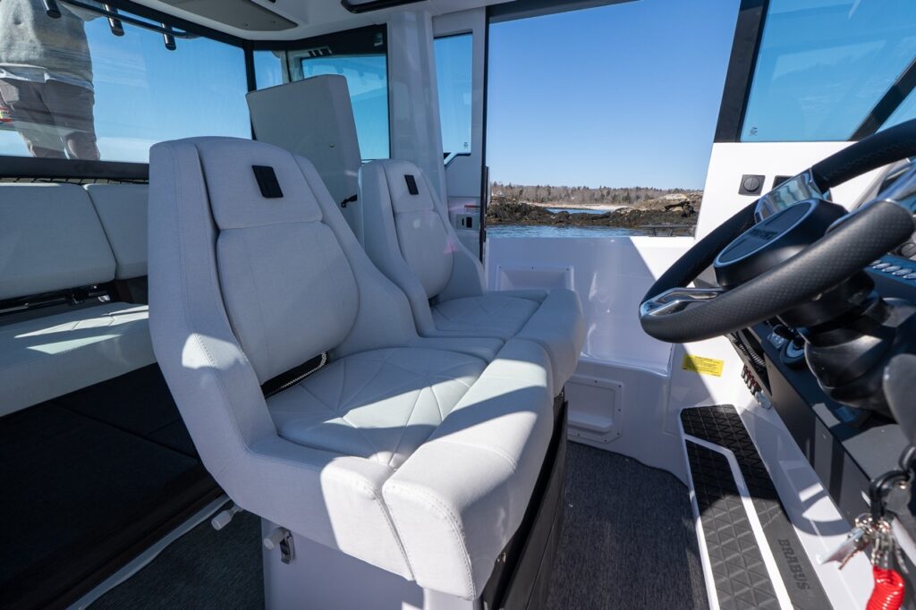 Axopar 29 XC Cross Cabin helm seats with white upholstery inside the pilothouse
