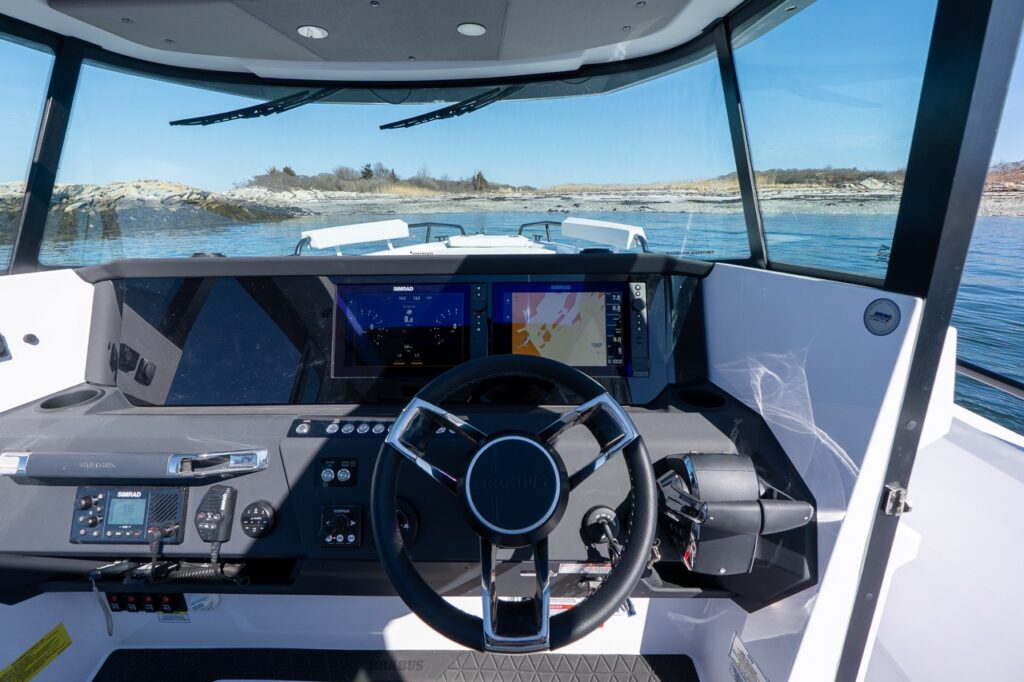Axopar 29 XC Cross Cabin helm with dual Simrad multifunction displays and panoramic forward visibility