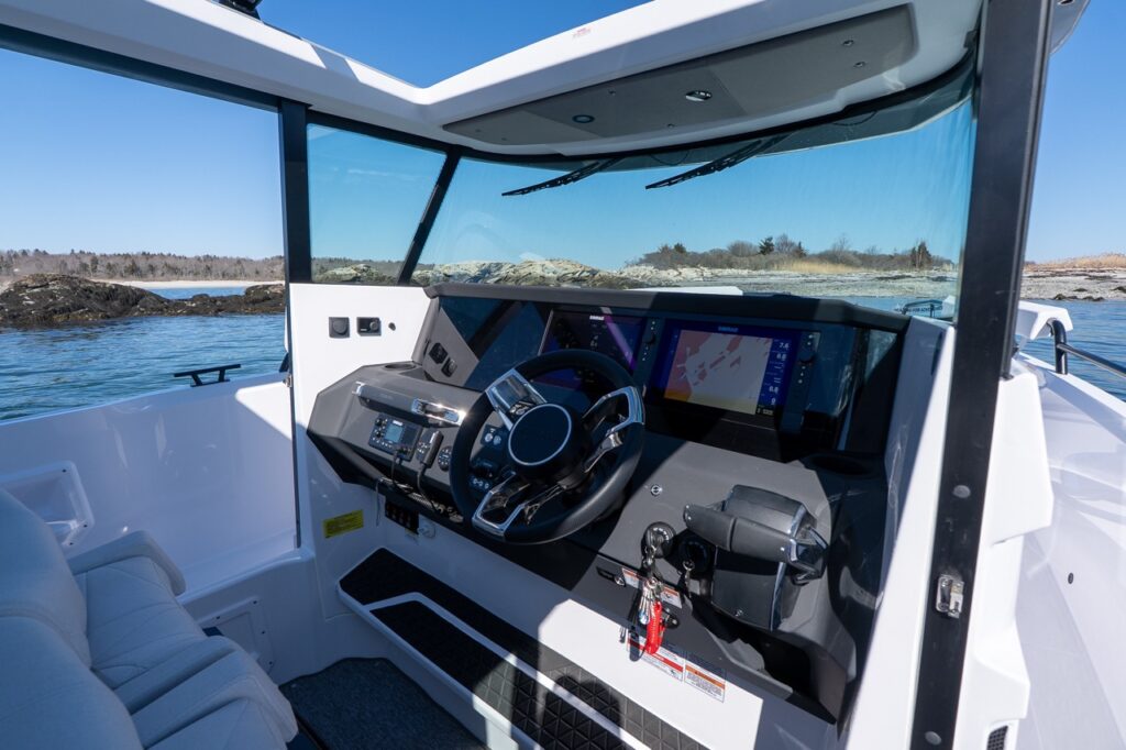 Axopar 29 XC Cross Cabin helm station with dual multifunction displays and panoramic pilothouse windows