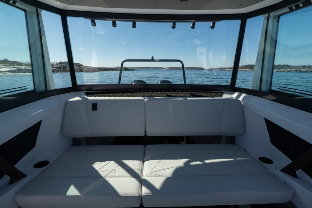 Axopar 29 XC Cross Cabin aft pilothouse bench seating with panoramic windows and ocean view