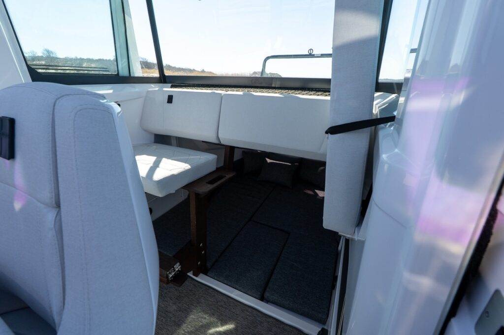 View from the pilothouse seating area looking down into the aft cabin berth of an Axopar 29
