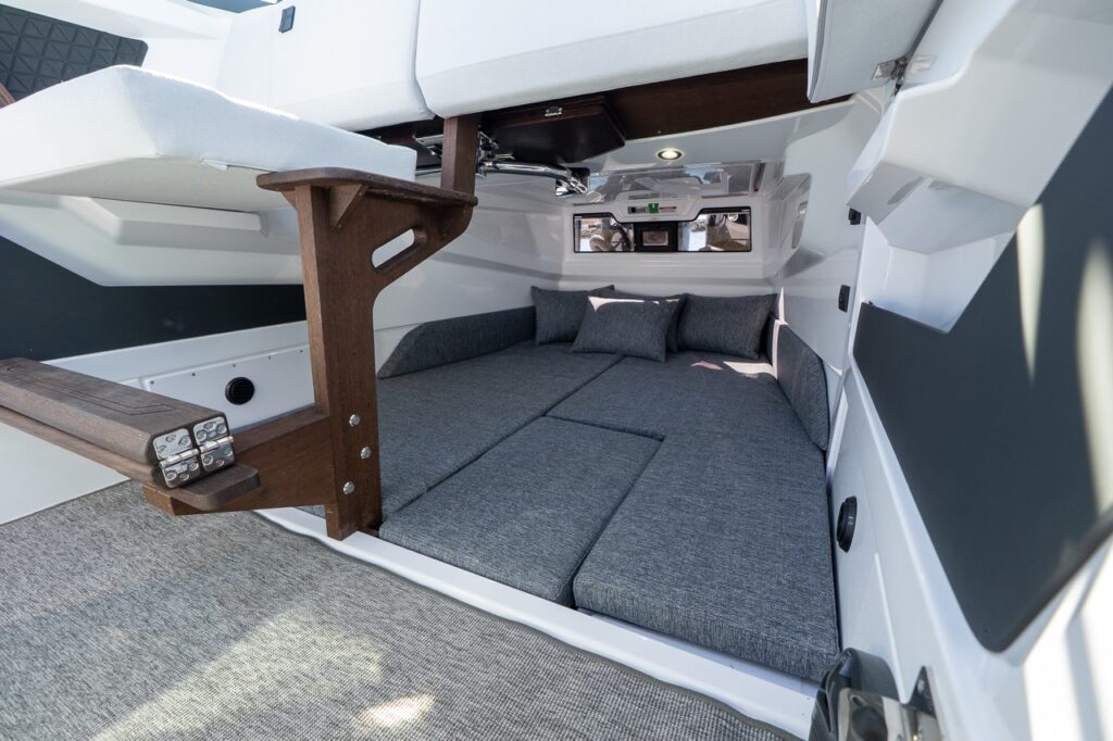 View looking aft from the pilothouse into the Axopar 29 aft cabin showing the double berth and cabin entry