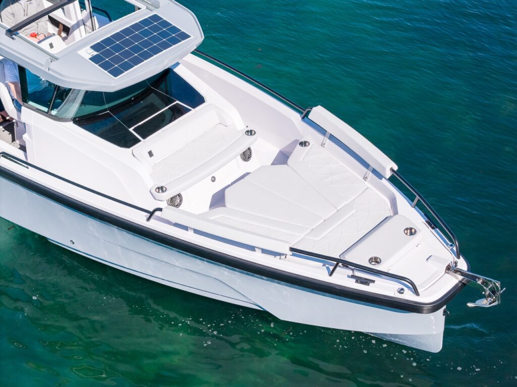 Axopar 29 bow seating and sunbed in Chalk upholstery with solar panel on pilothouse roof